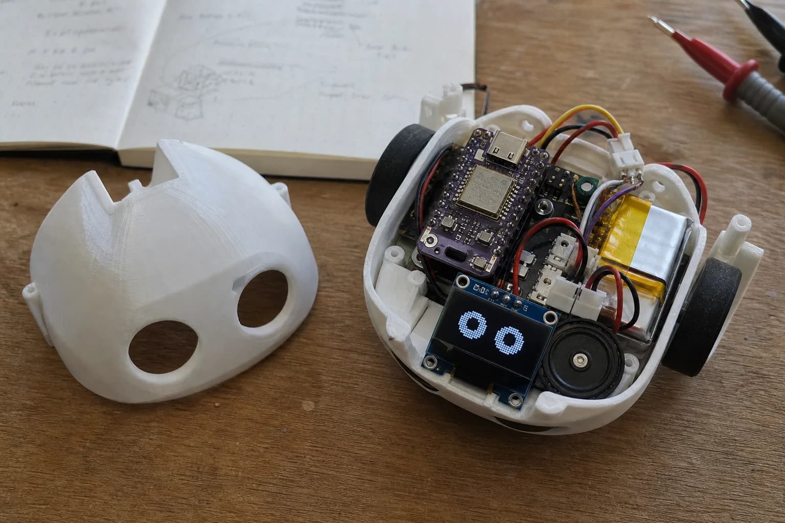 Opened Mochi prototype showing the controller, display, wiring and 3D-printed enclosure used during early hardware experiments