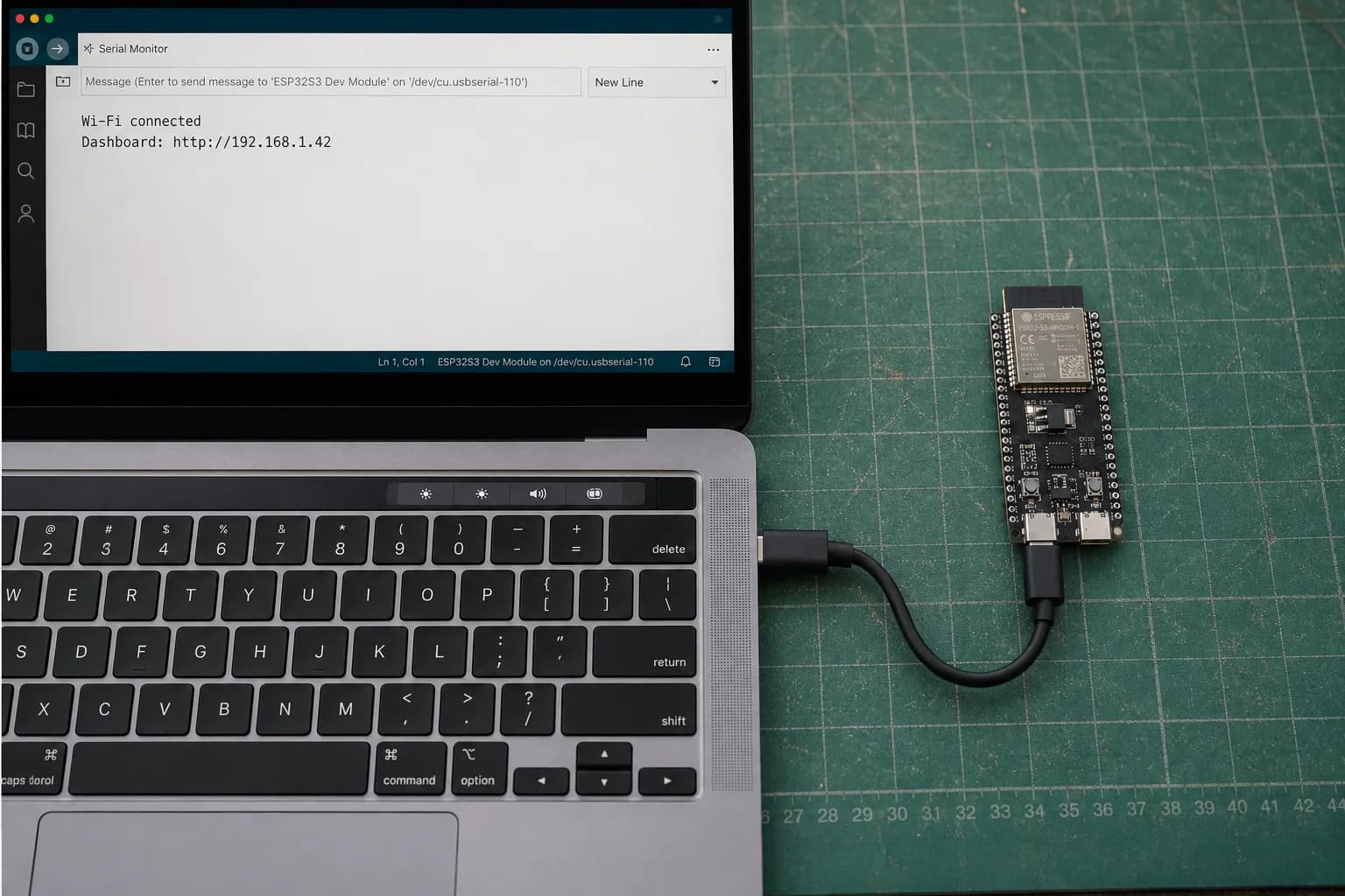 An ESP32-S3-DevKitC-1 correctly connected by USB-C to a MacBook Pro showing its IP address in Serial Monitor.
