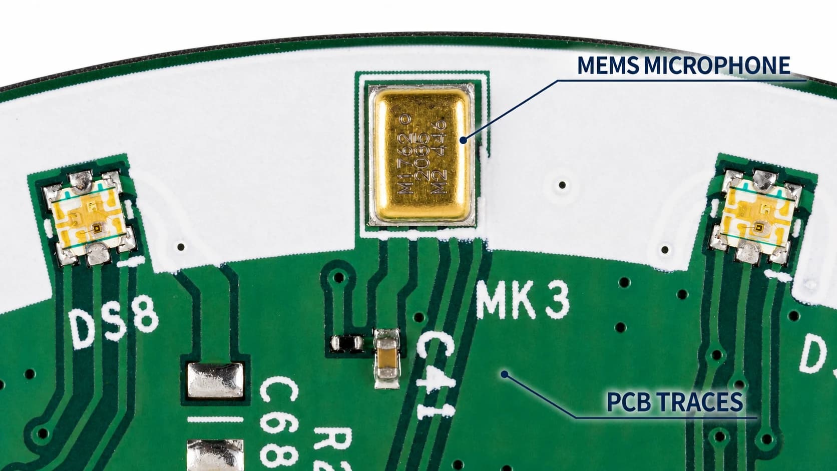 Macro photograph of a gold MEMS microphone and surrounding PCB traces.