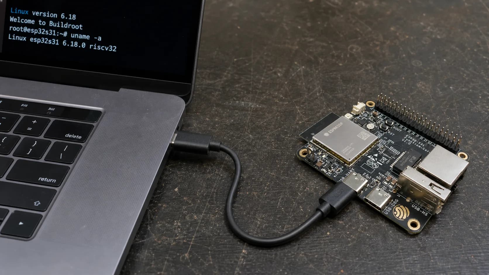 ESP32-S31 Linux BusyBox console displayed on a MacBook Pro over UART