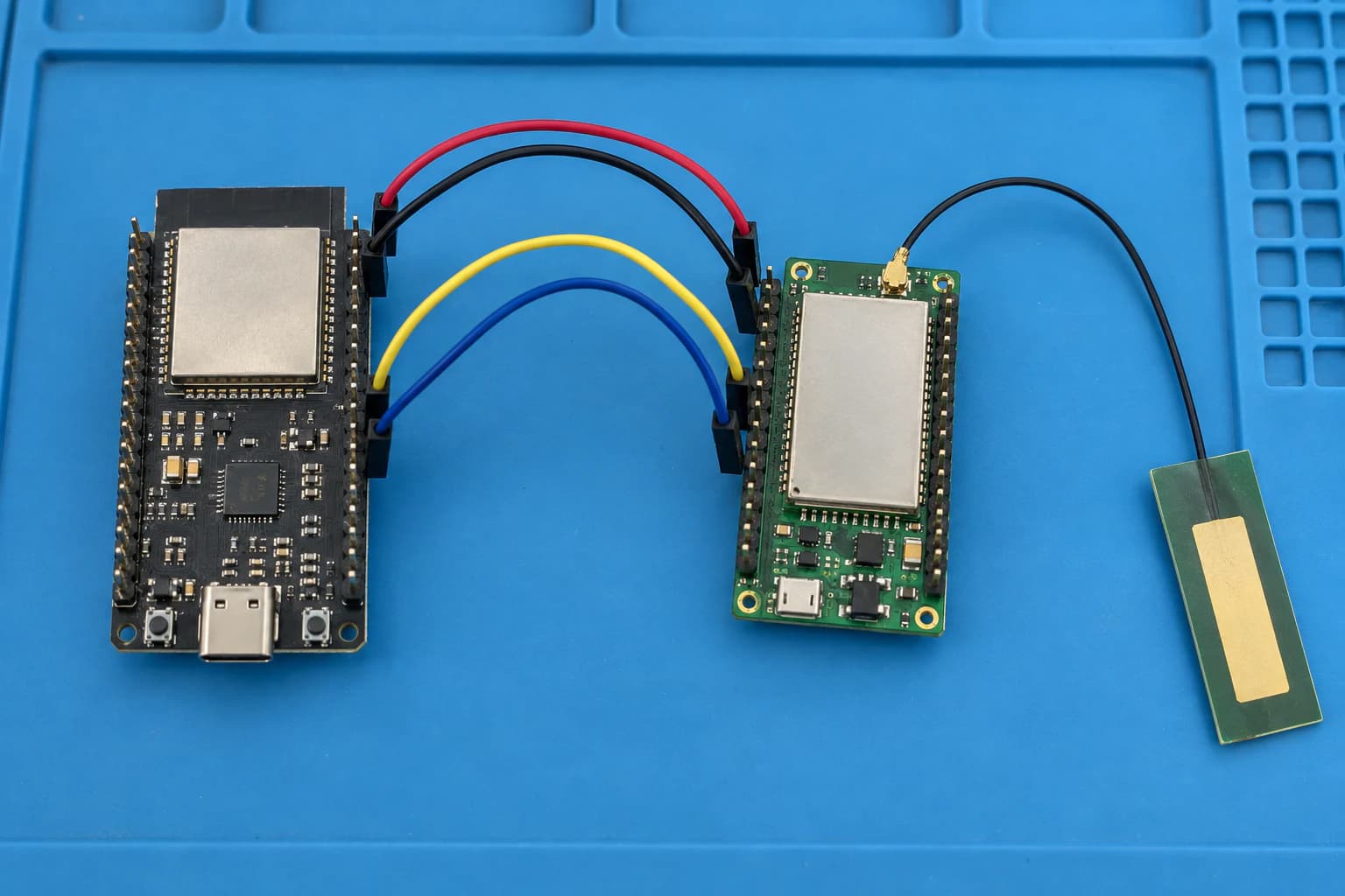 ESP32 connected over UART to a cellular modem and LTE antenna on a workbench