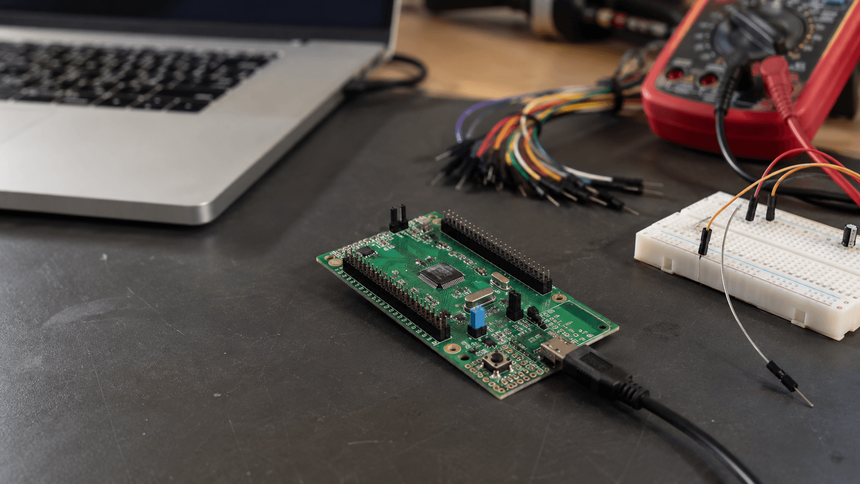 STM32 Nucleo development board connected to a laptop on a real electronics workbench